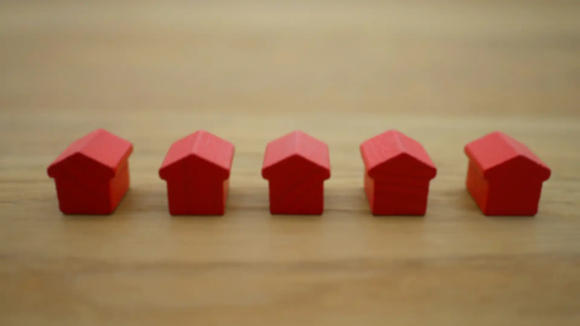 Five red monopoly houses sitting on a table
